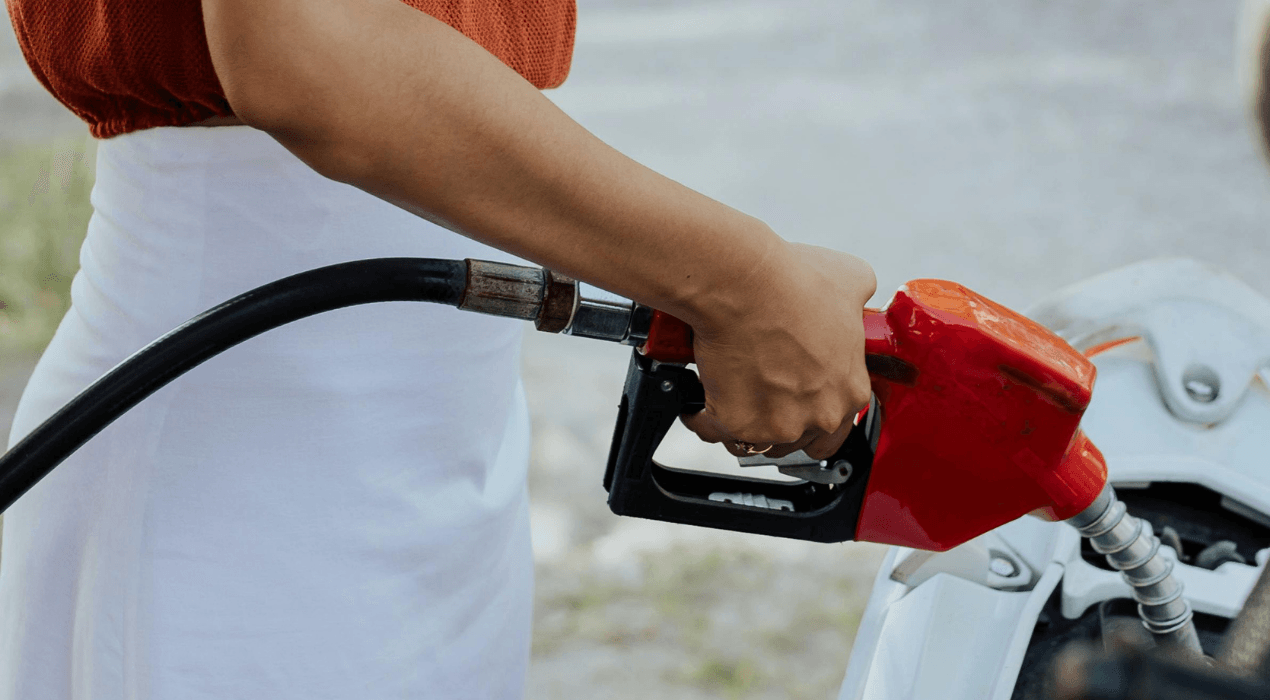 Person pumping gas into a car