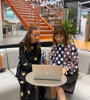 Two mortgage advisers looking at laptop