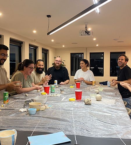 Group of Squirrels doing pottery at large table