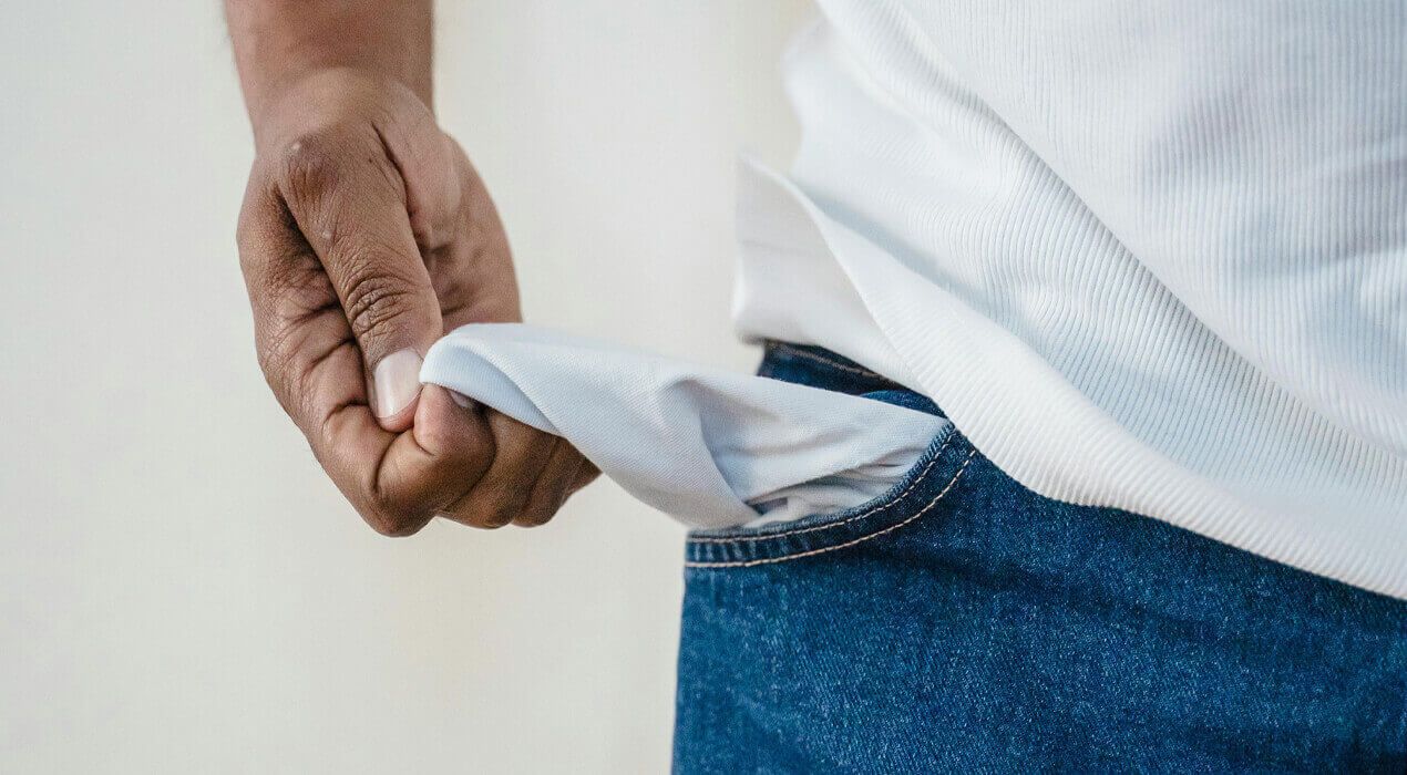 Close up image of a man turning out his empty pocket