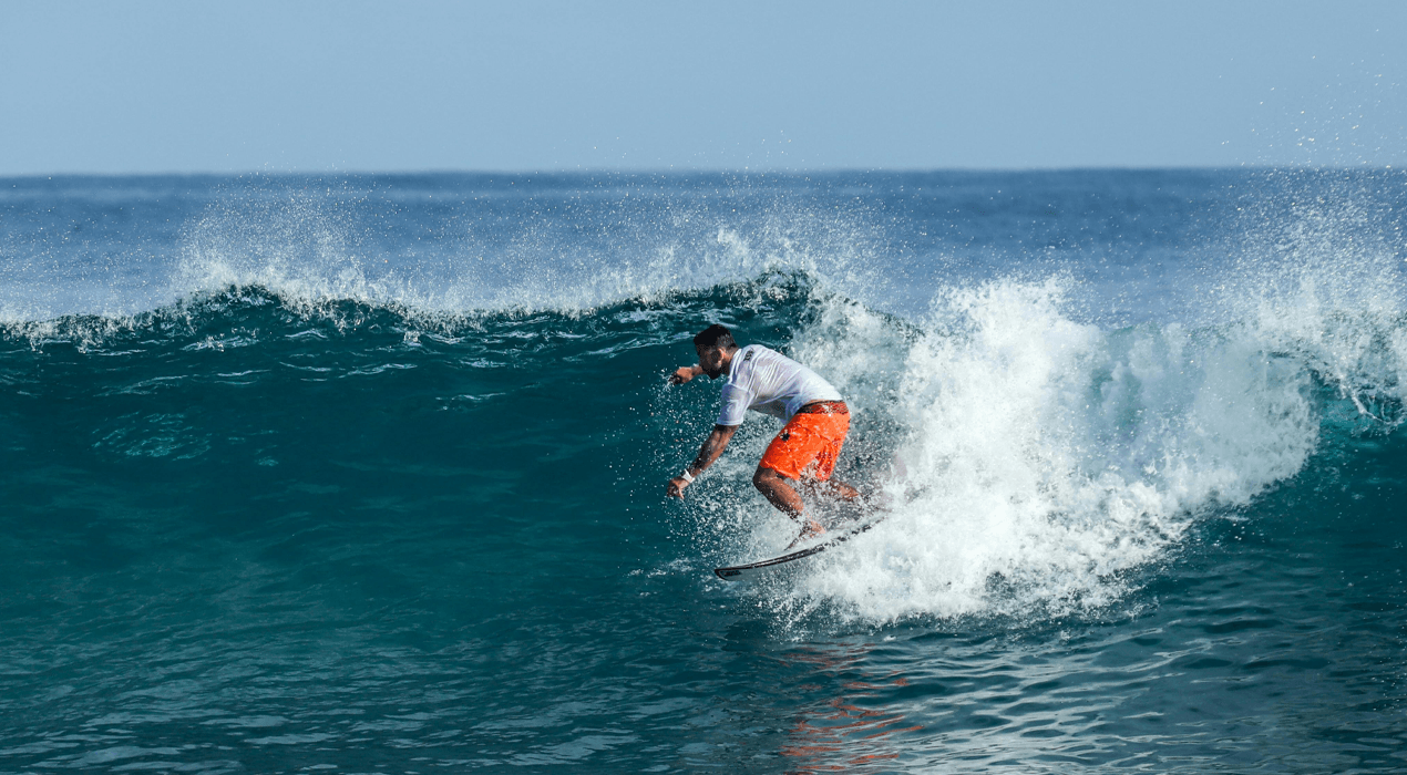 Person riding a wave on a surfboard