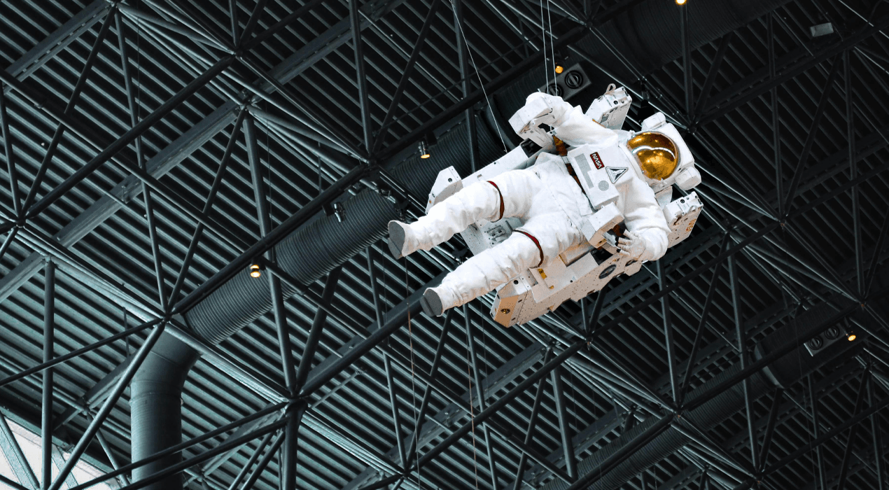 Spacesuit floating inside a warehouse-type environment