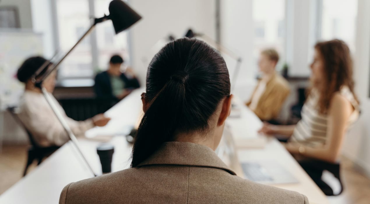 A group of women sitting around a board table.